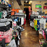 Interior of a retail store with various clothing items on display.