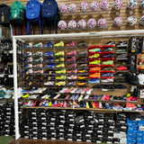 Shoe store with shelves displaying various shoes and sports equipment.