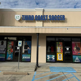 Storefront with 'Third Coast Soccer' sign against a blue sky with clouds
