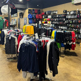 Store interior with clothing racks and shelves displaying various items.