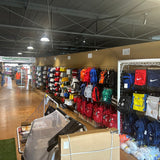 Store interior with backpacks and sports equipment on display